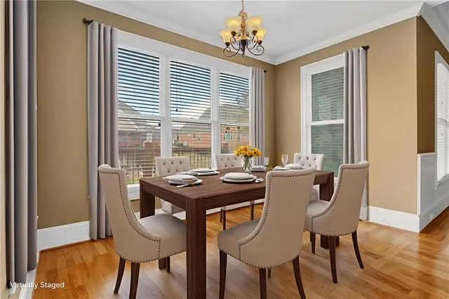 a view of a dining room with furniture and wooden floor