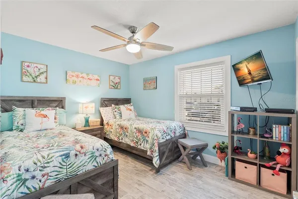 a bedroom with a bed a dresser and a book shelf