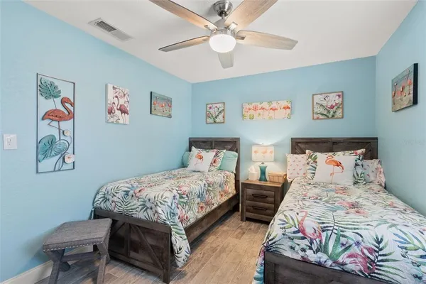 a bedroom with a bed and a chandelier