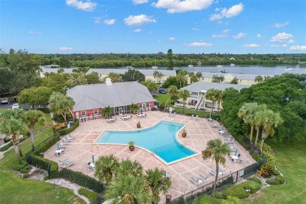 an aerial view of residential houses with outdoor space and river