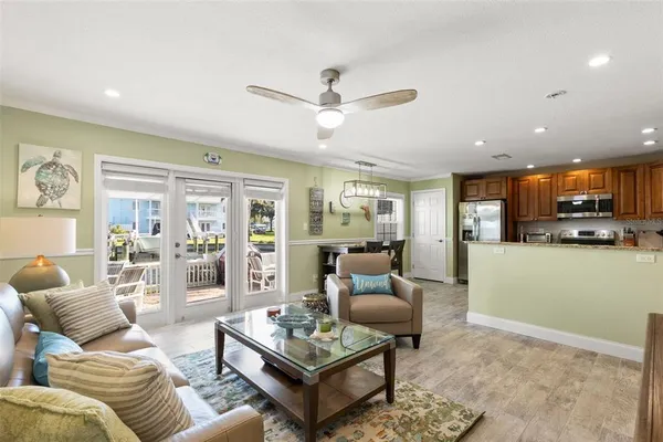 a living room with furniture and a view of kitchen