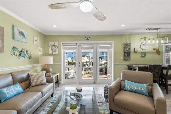 a living room with furniture and a chandelier