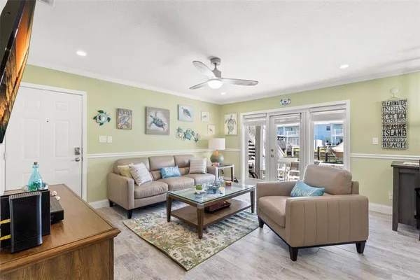 a living room with furniture ceiling fan and a rug