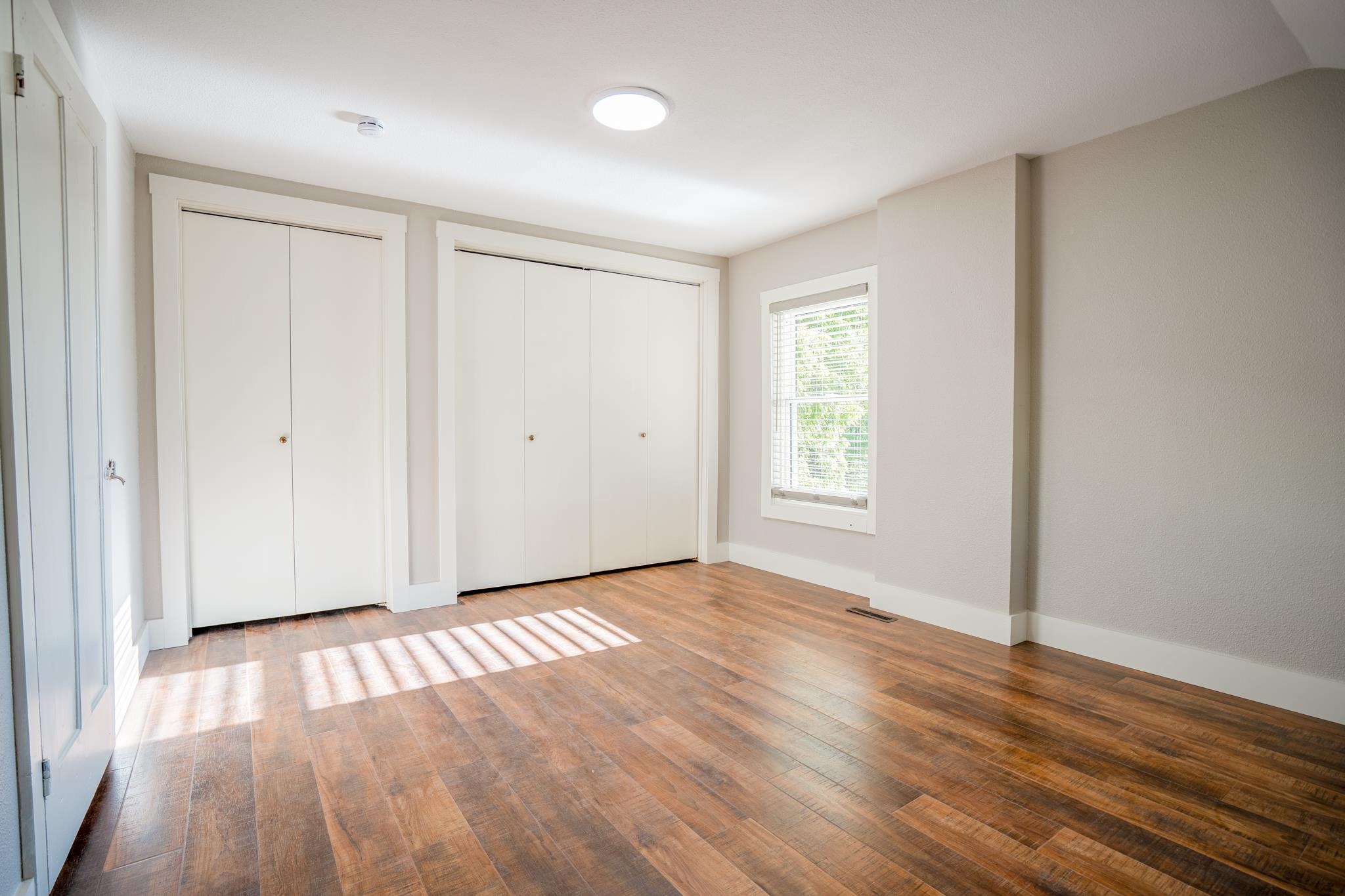 2368 West Winneshiek Road Freeport, IL 61032 - Photo 21 of 39 a view of an empty room with wooden floor and a window