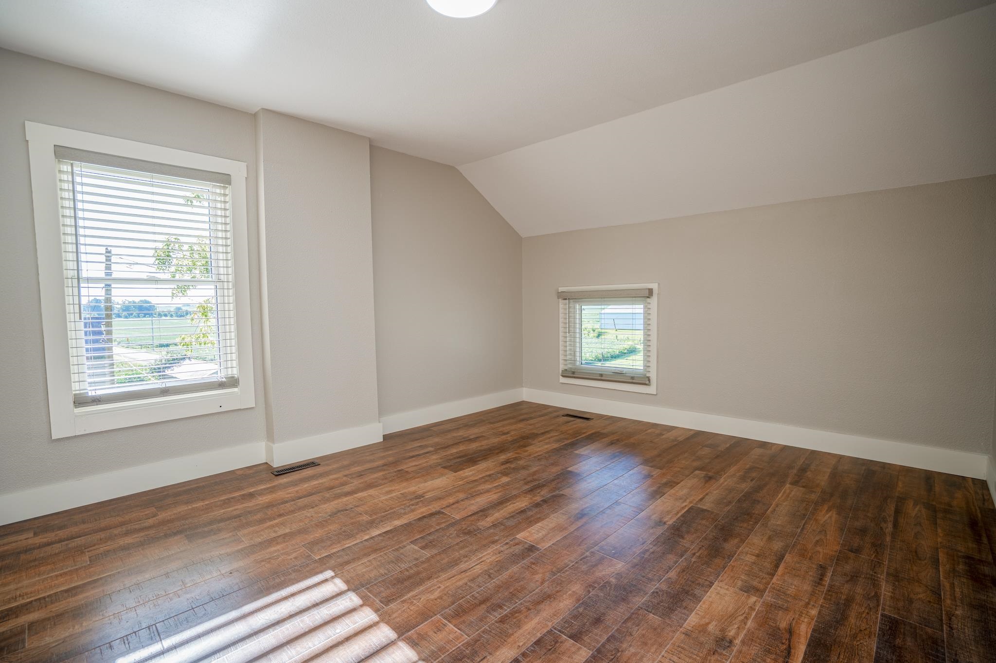 2368 West Winneshiek Road Freeport, IL 61032 - Photo 22 of 39 a view of an empty room with wooden floor and a window