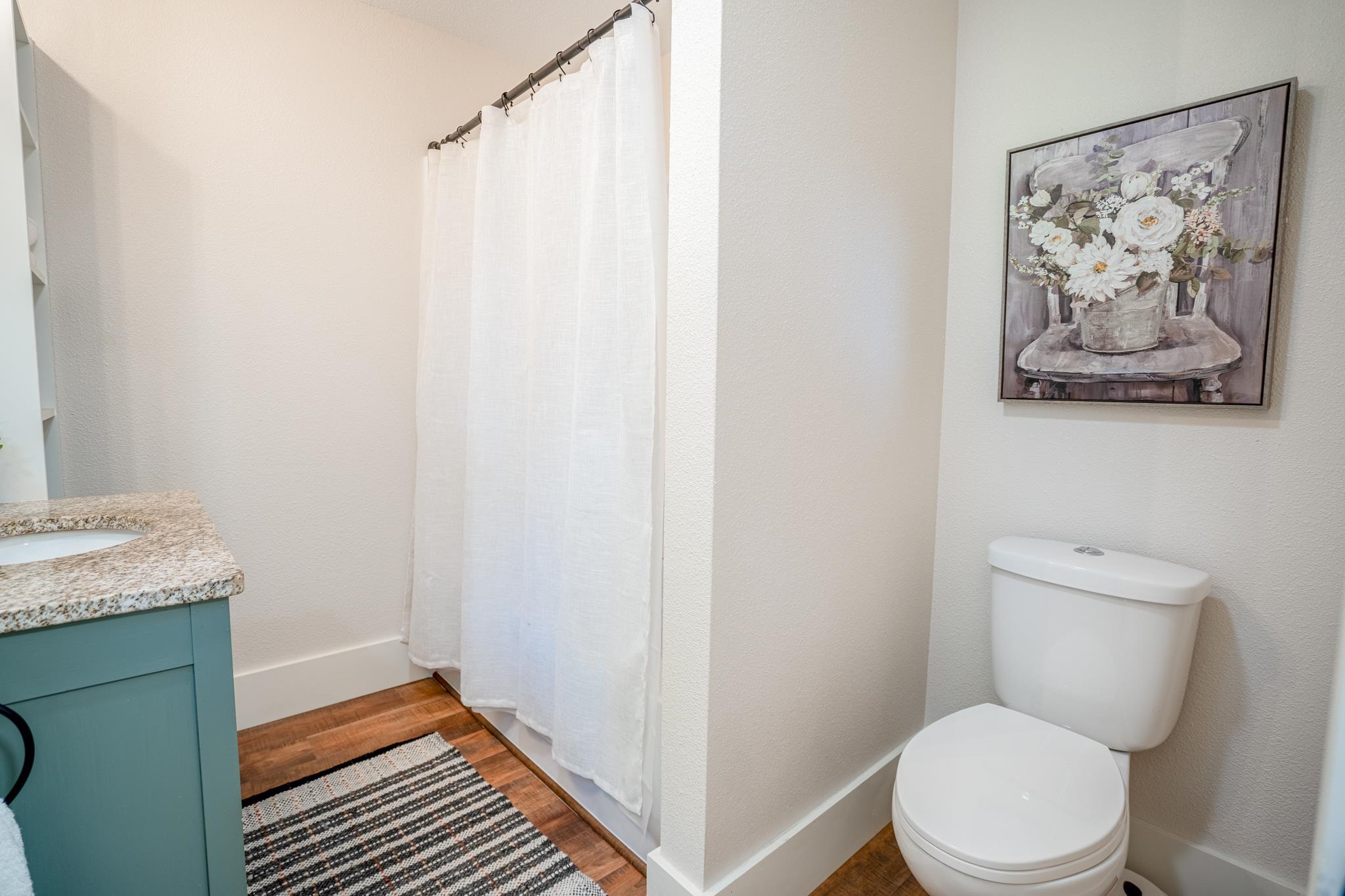 2368 West Winneshiek Road Freeport, IL 61032 - Photo 10 of 39 a bathroom with a toilet a sink and wooden floor