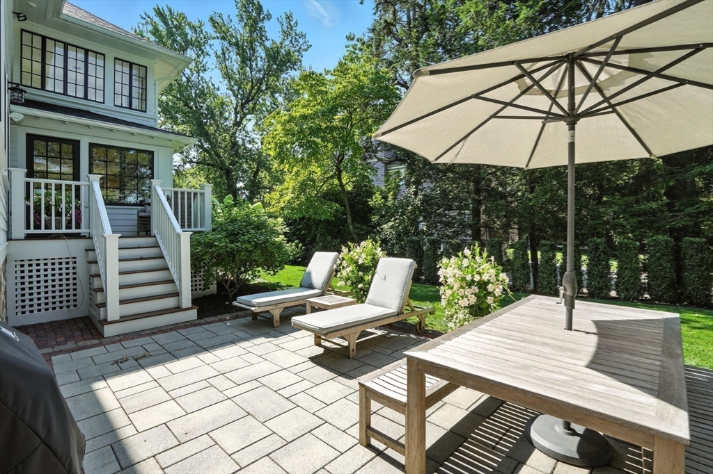 15 Winthrop Road Lexington, MA 02421 - Photo 37 of 39 a view of a patio with a table chairs and a barbeque