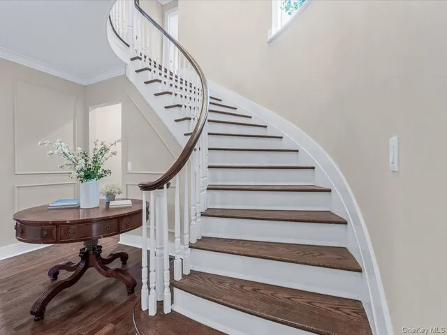 an empty room with wooden floor and window