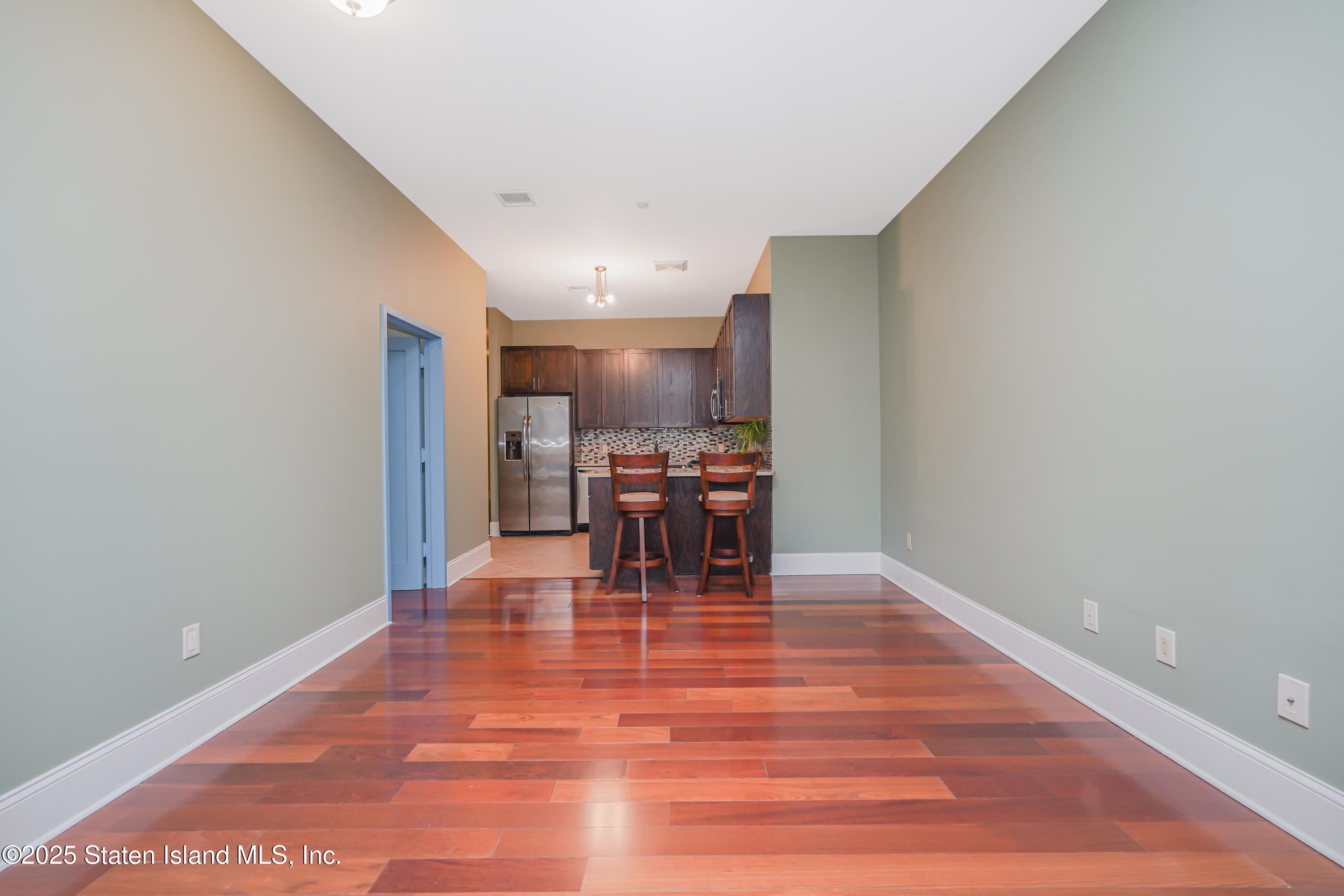 90 Bay Street Landing, Unit 1E Staten Island, NY 10301 - Photo 13 of 43 a view of a kitchen with dining table and chairs