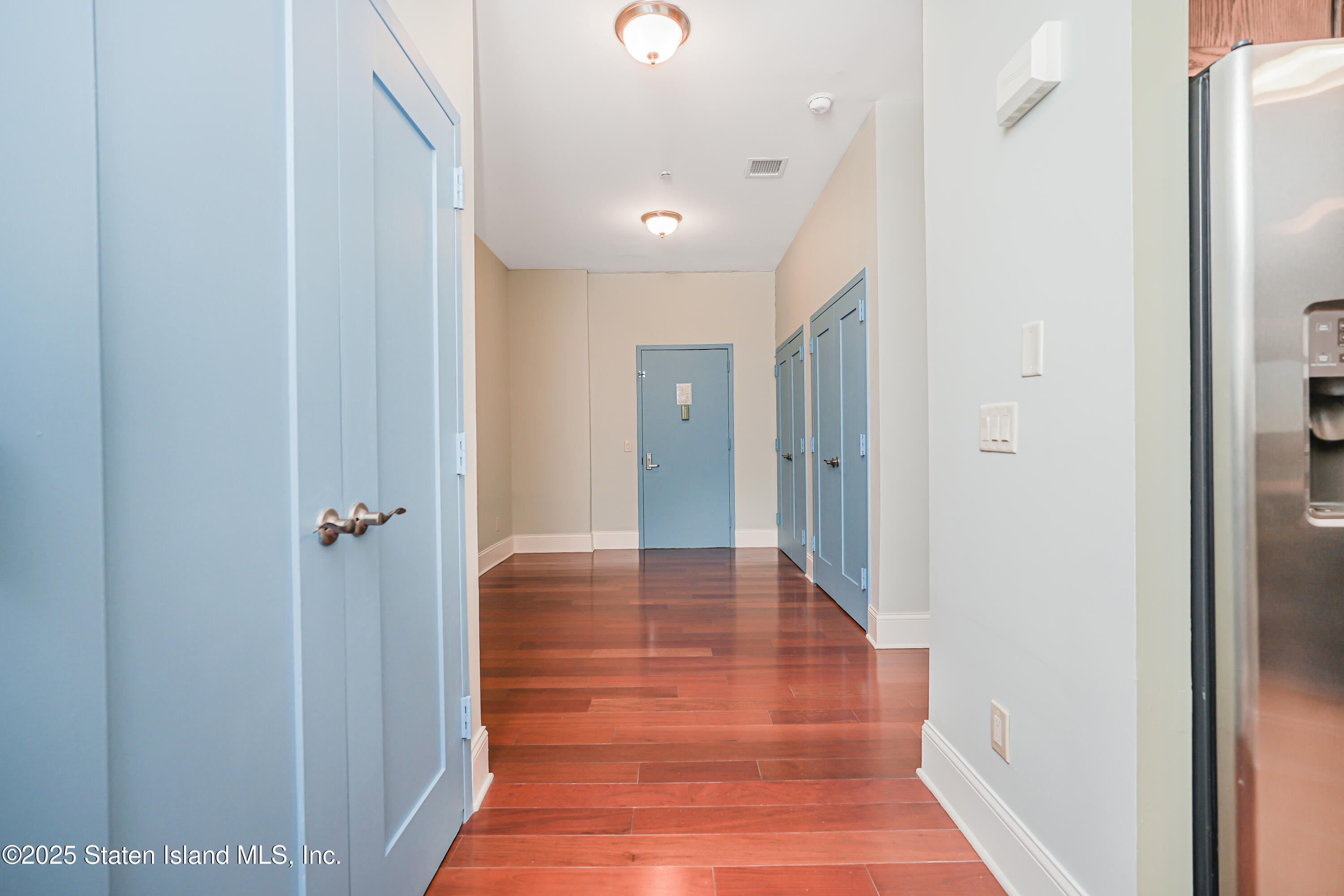 90 Bay Street Landing, Unit 1E Staten Island, NY 10301 - Photo 14 of 43 a view of a hallway with wooden floor