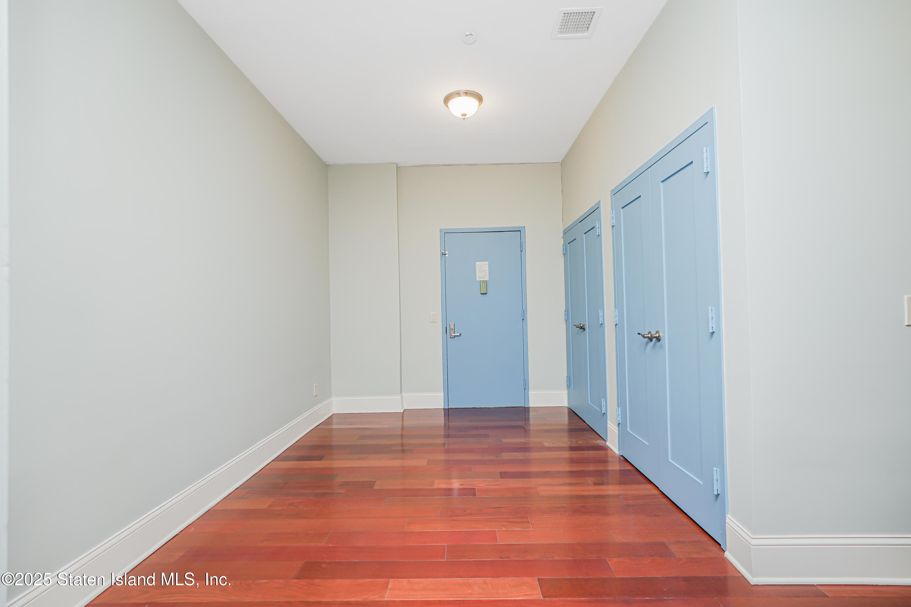 90 Bay Street Landing, Unit 1E Staten Island, NY 10301 - Photo 15 of 43 a view of an empty room with wooden floor