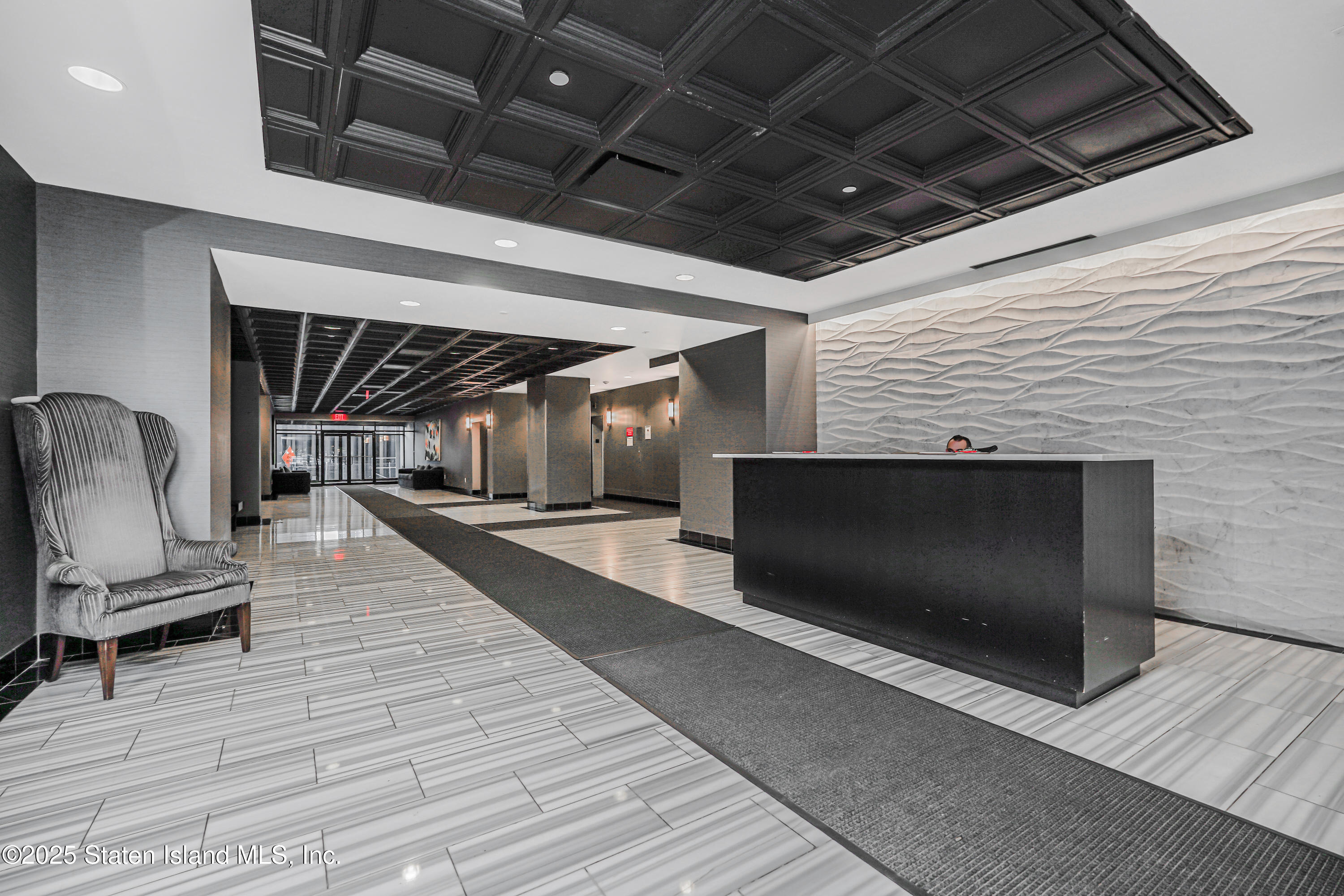 90 Bay Street Landing, Unit 1E Staten Island, NY 10301 - Photo 2 of 43 a lobby with furniture and a floor to ceiling window