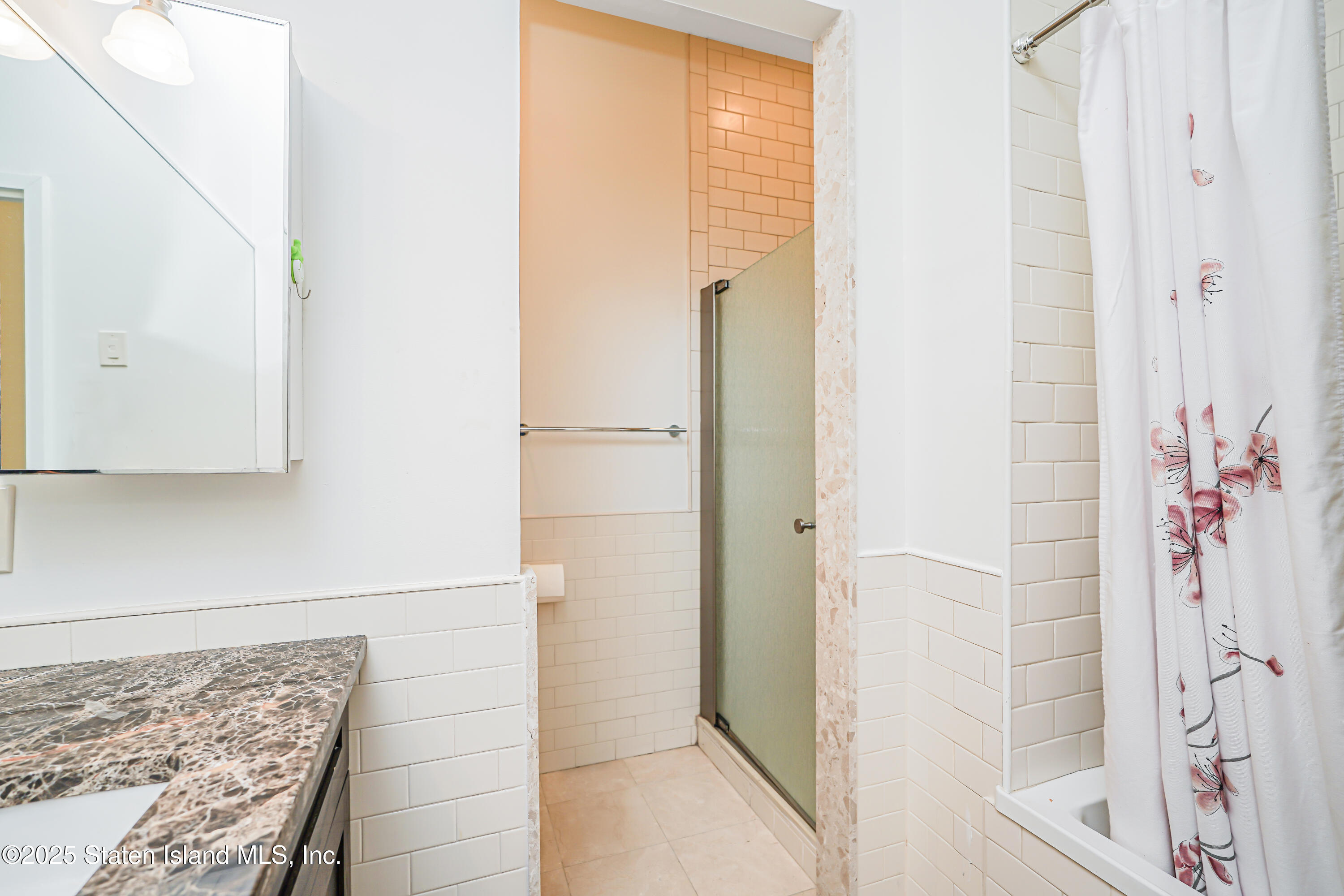 90 Bay Street Landing, Unit 1E Staten Island, NY 10301 - Photo 24 of 43 a bathroom with a bathtub and shower