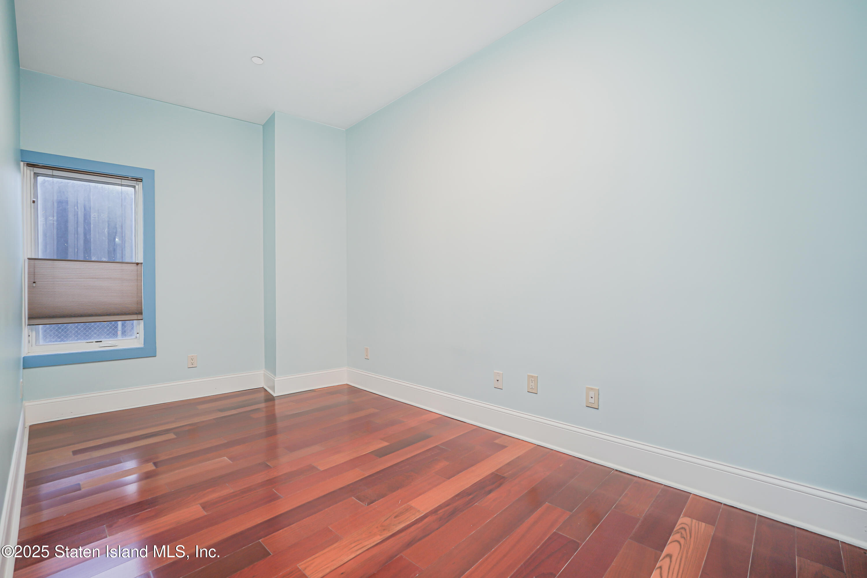 90 Bay Street Landing, Unit 1E Staten Island, NY 10301 - Photo 26 of 43 an empty room with a wooden floor and closet