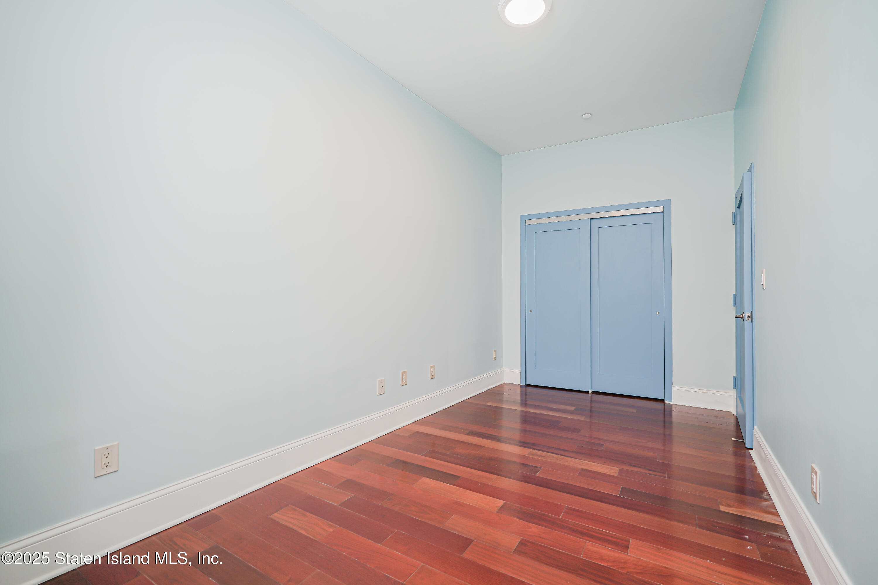90 Bay Street Landing, Unit 1E Staten Island, NY 10301 - Photo 28 of 43 a view of an empty room with wooden floor