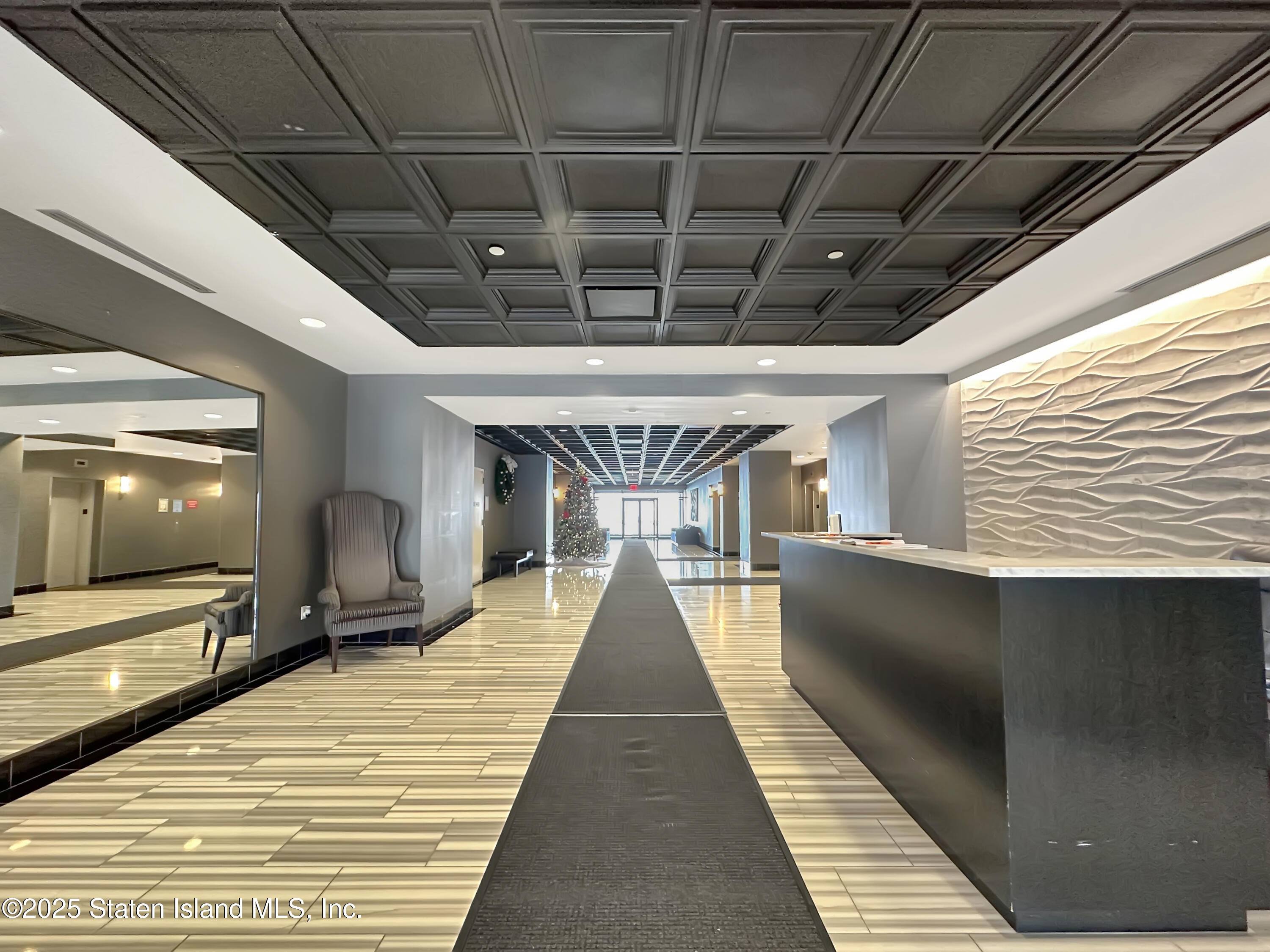 90 Bay Street Landing, Unit 1E Staten Island, NY 10301 - Photo 3 of 43 a view of a hall with wooden floor and furniture