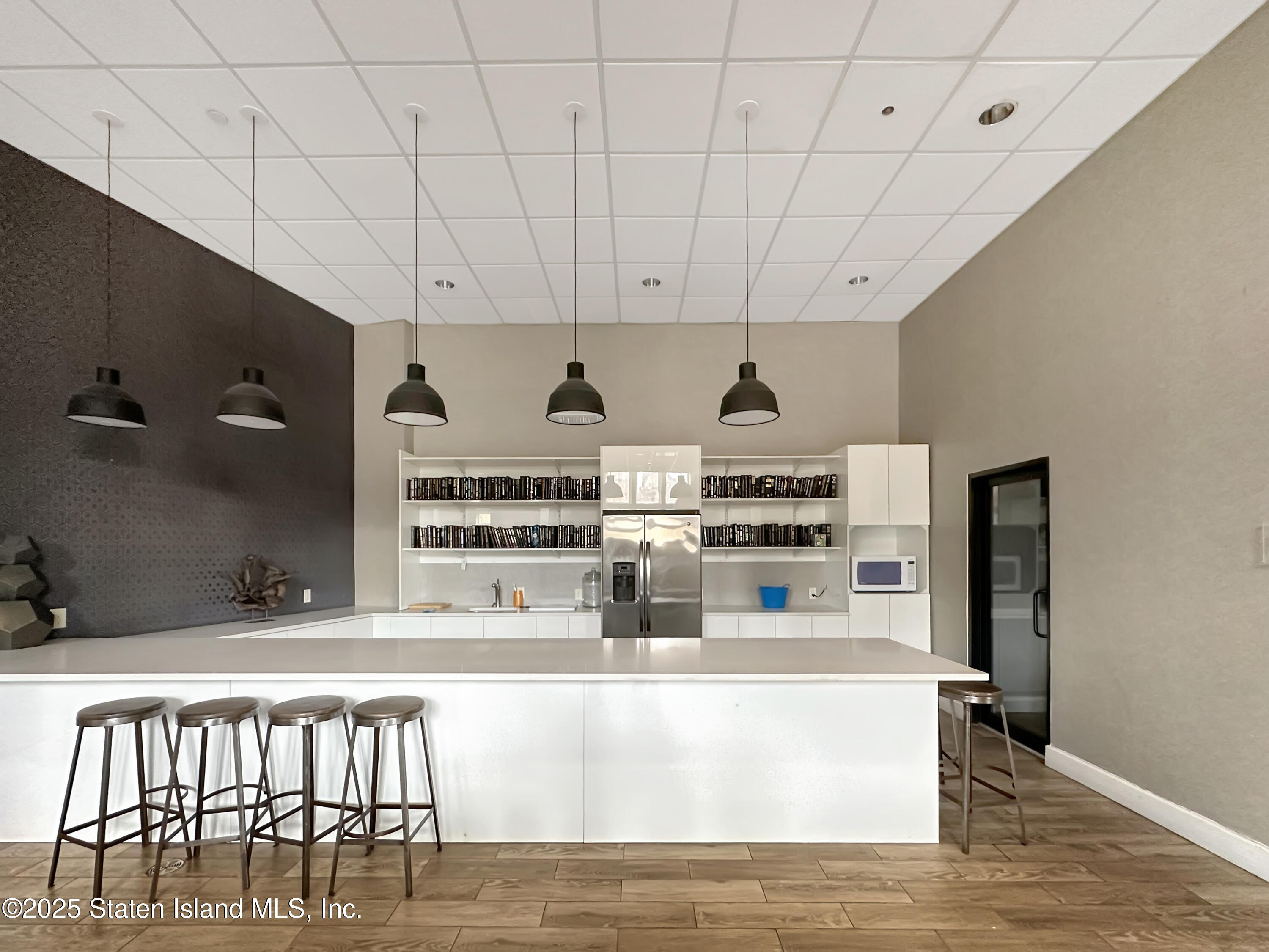 90 Bay Street Landing, Unit 1E Staten Island, NY 10301 - Photo 31 of 43 a kitchen with kitchen island stainless steel appliances a sink and cabinets