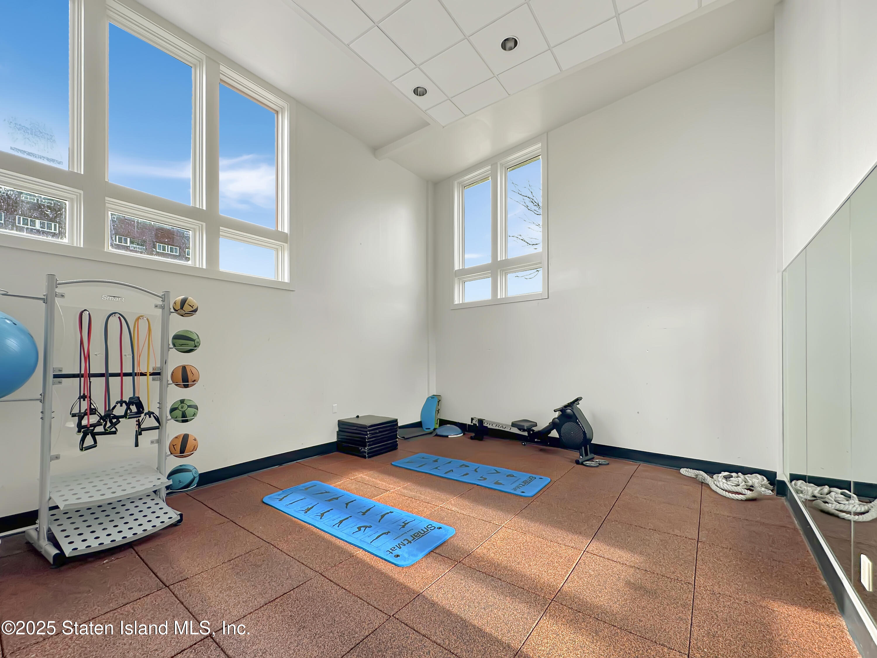 90 Bay Street Landing, Unit 1E Staten Island, NY 10301 - Photo 37 of 43 a room with gym equipment and a rug