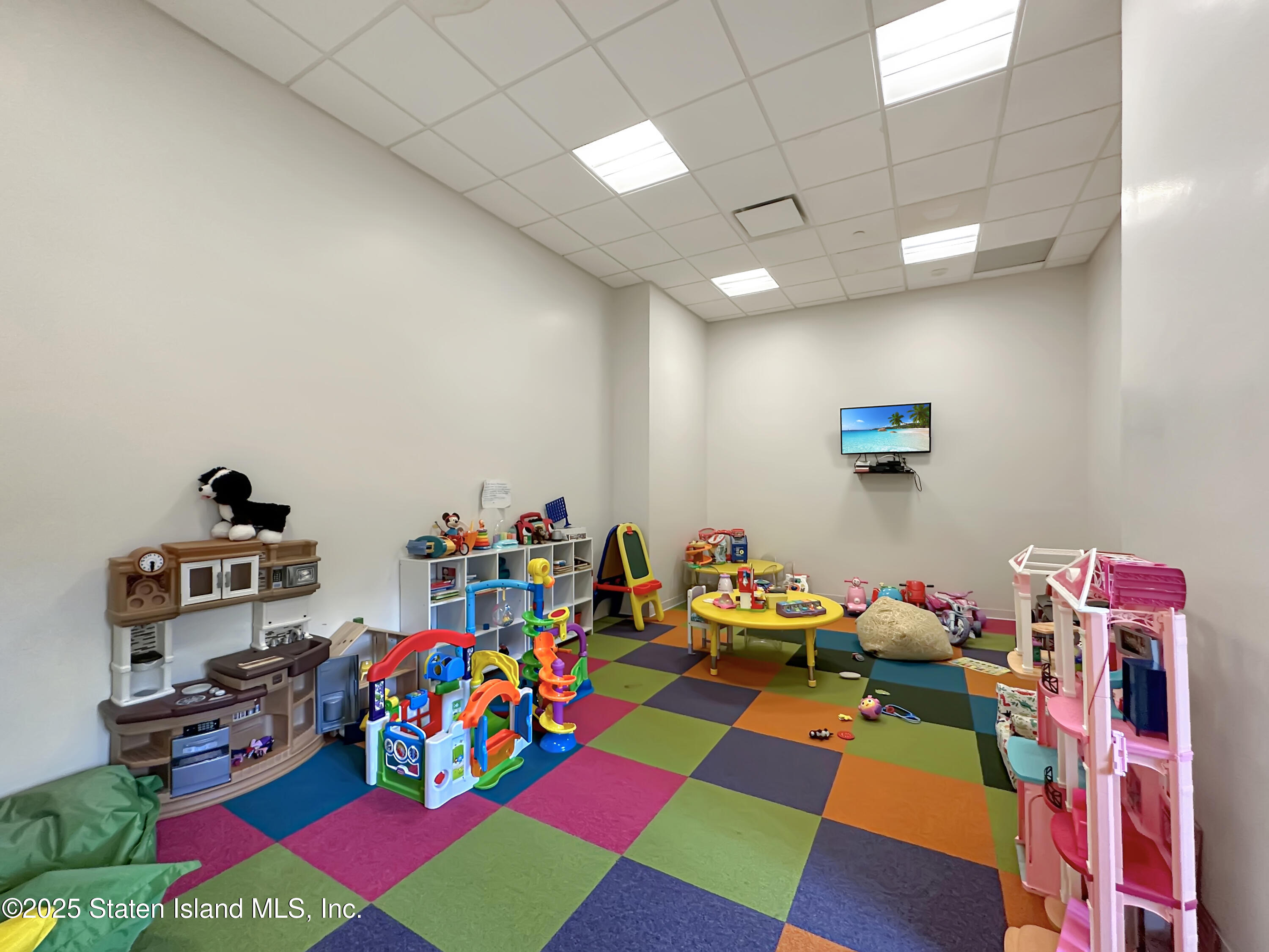 90 Bay Street Landing, Unit 1E Staten Island, NY 10301 - Photo 38 of 43 a room with lots of baby toys and hanging chair