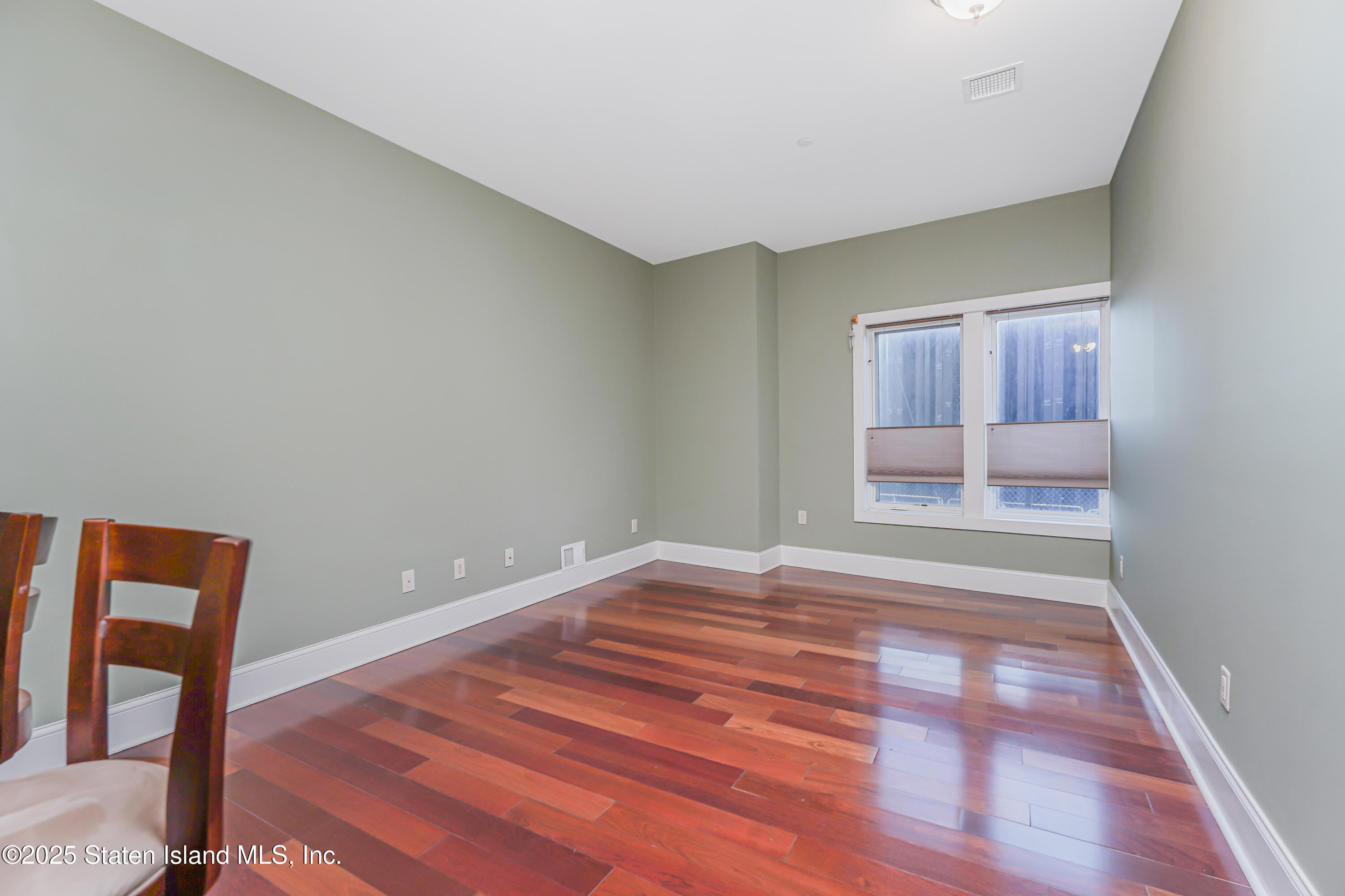90 Bay Street Landing, Unit 1E Staten Island, NY 10301 - Photo 4 of 43 a view of empty room with wooden floor and fan