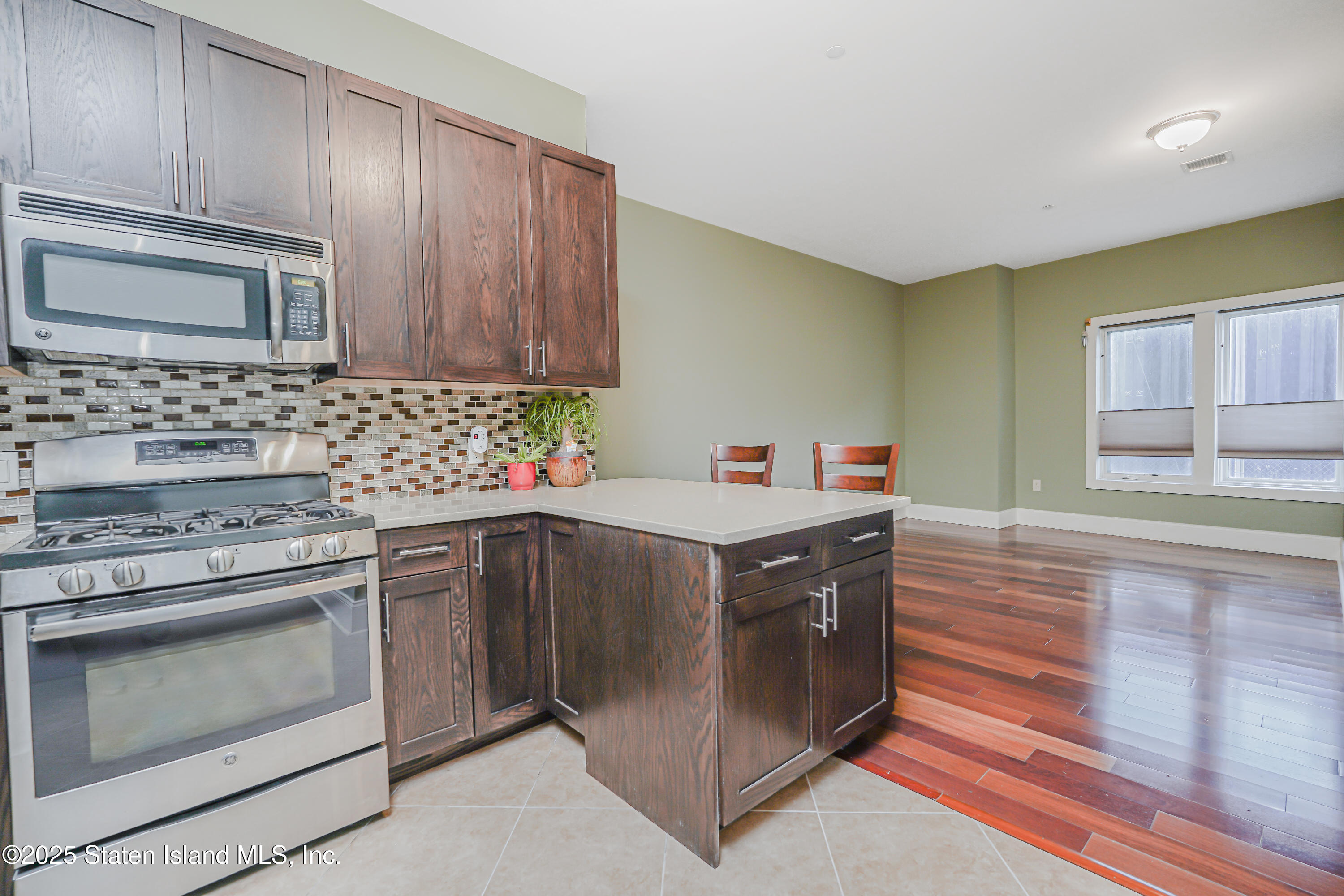 90 Bay Street Landing, Unit 1E Staten Island, NY 10301 - Photo 8 of 43 a kitchen with a stove top oven sink and cabinets