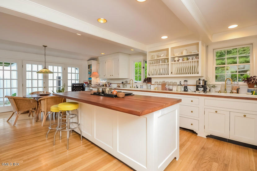 127 Dingletown Road Greenwich, CT 06830 - Photo 11 of 48 a kitchen with stainless steel appliances kitchen island granite countertop a stove a sink a refrigerator and white cabinets with wooden floor