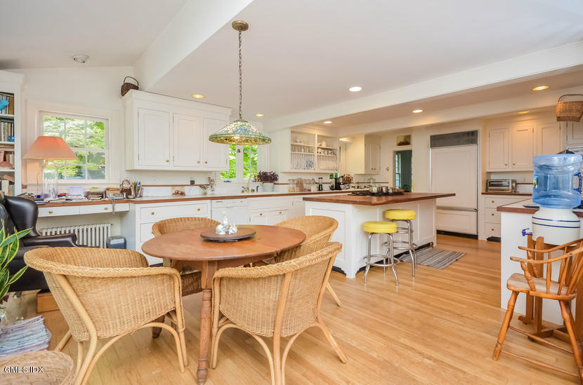 127 Dingletown Road Greenwich, CT 06830 - Photo 13 of 48 a kitchen with stainless steel appliances kitchen island granite countertop a dining table chairs and view living room