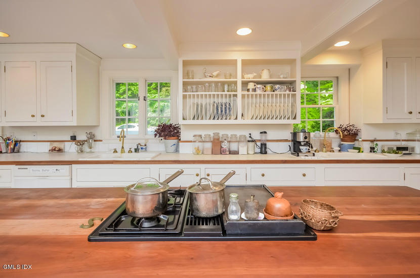 127 Dingletown Road Greenwich, CT 06830 - Photo 15 of 48 a kitchen with a stove a sink and a window