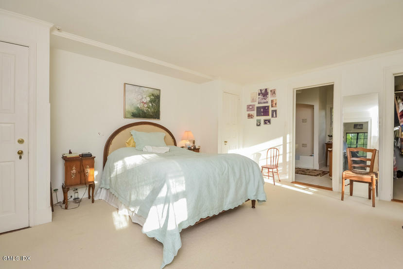 127 Dingletown Road Greenwich, CT 06830 - Photo 23 of 48 a spacious bedroom with a bed and a cabinets