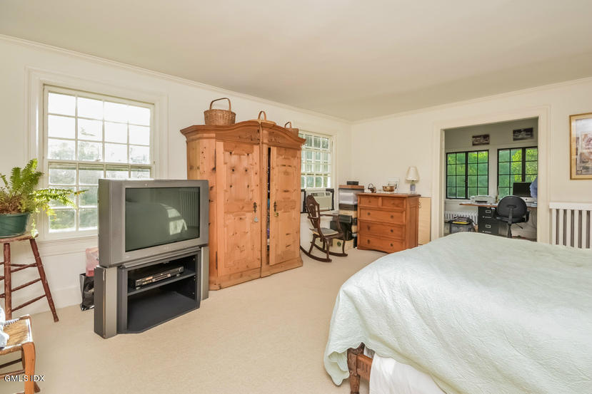 127 Dingletown Road Greenwich, CT 06830 - Photo 25 of 48 a bedroom with furniture and a flat screen tv
