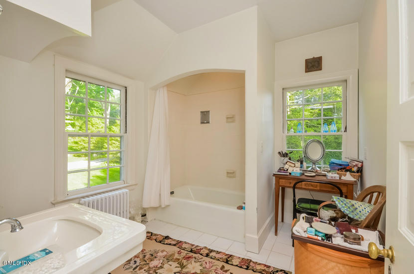 127 Dingletown Road Greenwich, CT 06830 - Photo 26 of 48 a bath room with a bath tub and a window