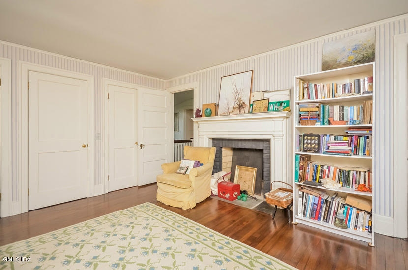 127 Dingletown Road Greenwich, CT 06830 - Photo 27 of 48 a living room with furniture and a book shelf