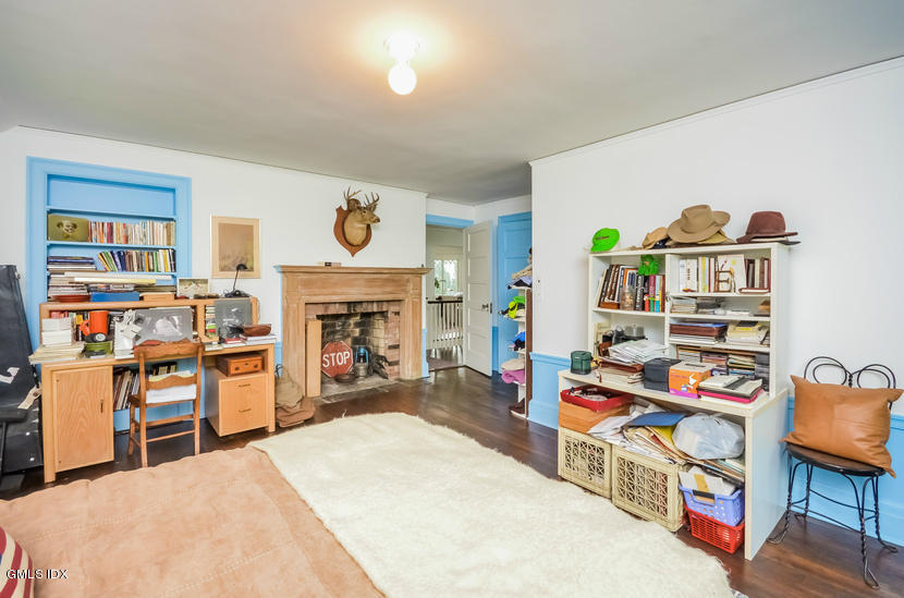 127 Dingletown Road Greenwich, CT 06830 - Photo 30 of 48 a room with furniture a rug and a bookshelf