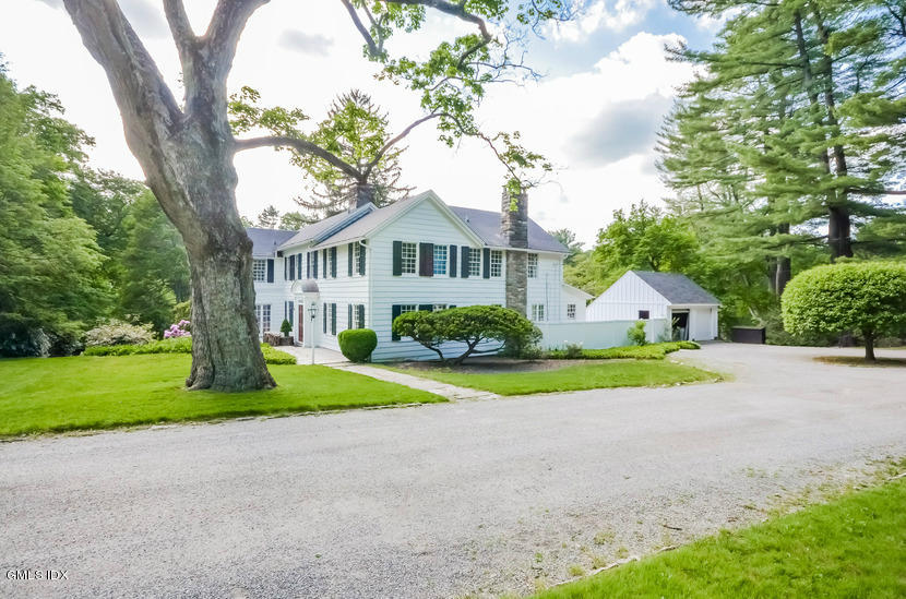 127 Dingletown Road Greenwich, CT 06830 - Photo 40 of 48 a front view of a house with a yard and garage