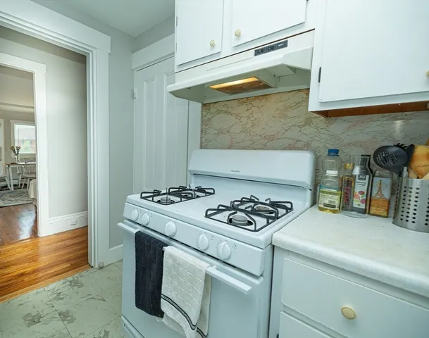 a kitchen with stove and cabinets