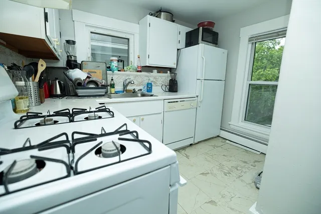 a kitchen with a refrigerator and a stove
