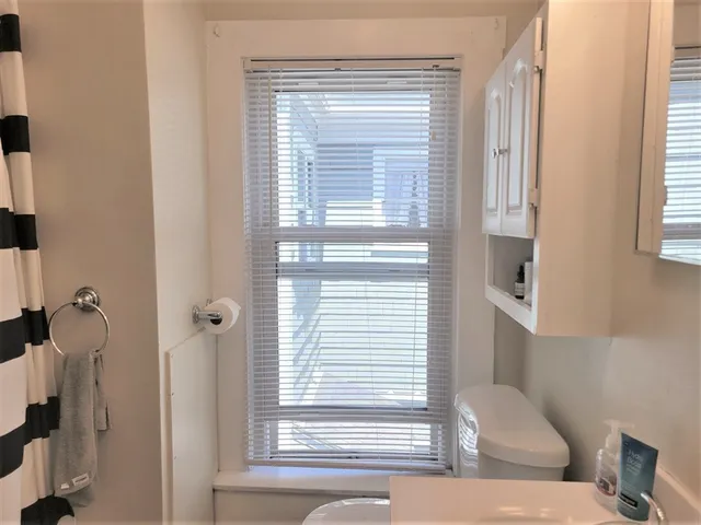 a view of a bathroom with a bathtub and windows