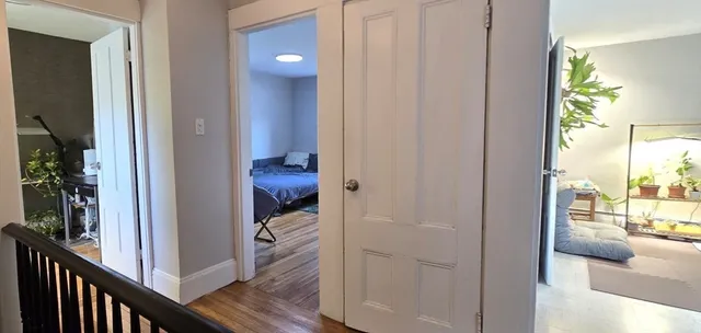 a view of a hallway with furniture and floor to living room