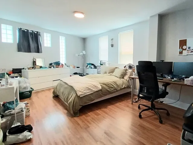 a bedroom with a bed and a desk