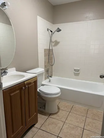 a bathroom with a granite countertop toilet a sink and a mirror