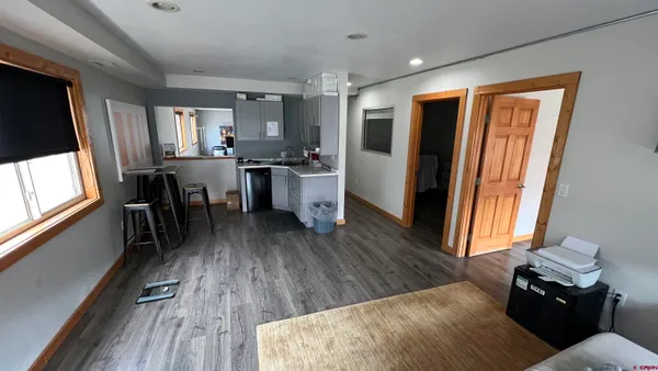 a kitchen with a table chairs refrigerator and window