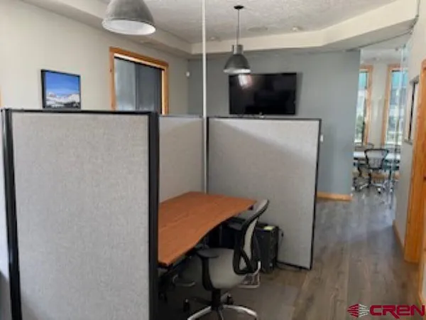 a view of a livingroom with furniture and a flat screen tv