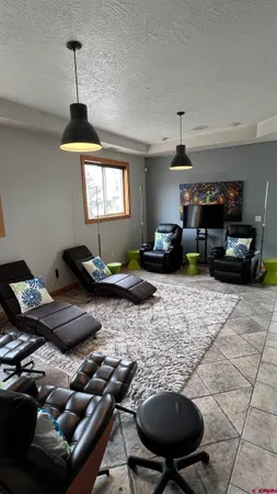 a living room with furniture and a chandelier
