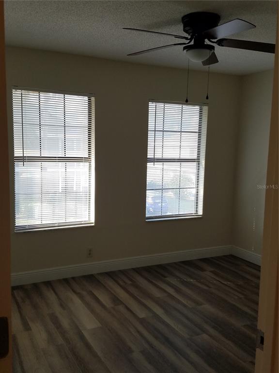 505 Boxelder Avenue Altamonte Springs, FL 32714 - Photo 7 of 10 an empty room with wooden floor and windows