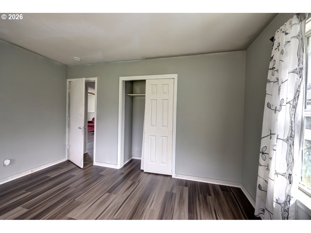 308 1st Street Garibaldi, OR 97118 - Photo 12 of 48 a view of an empty room with wooden floor and a window