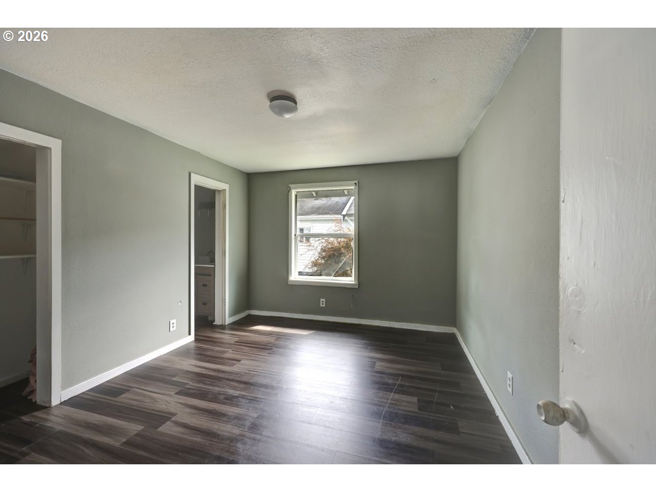 308 1st Street Garibaldi, OR 97118 - Photo 15 of 48 a view of an empty room with wooden floor and a window
