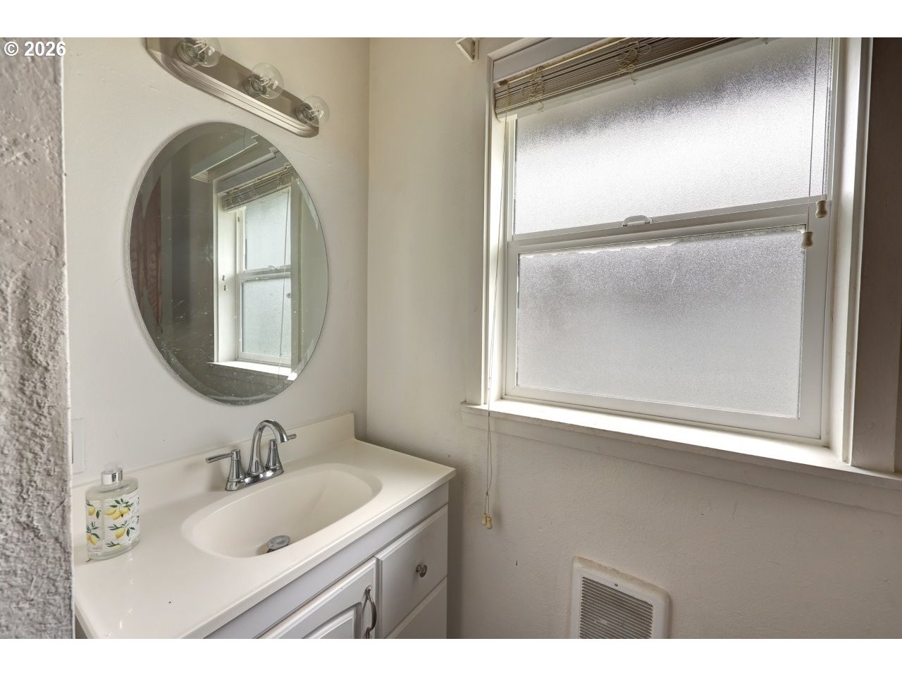 308 1st Street Garibaldi, OR 97118 - Photo 35 of 48 a bathroom with a sink and a mirror