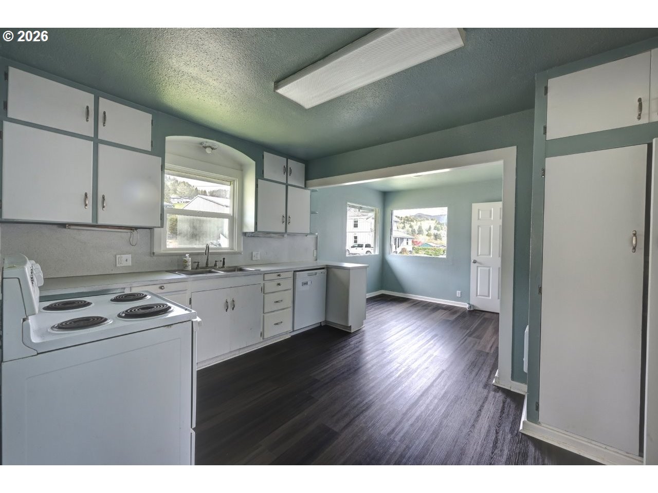 308 1st Street Garibaldi, OR 97118 - Photo 37 of 48 a kitchen with cabinets wooden floor and a sink