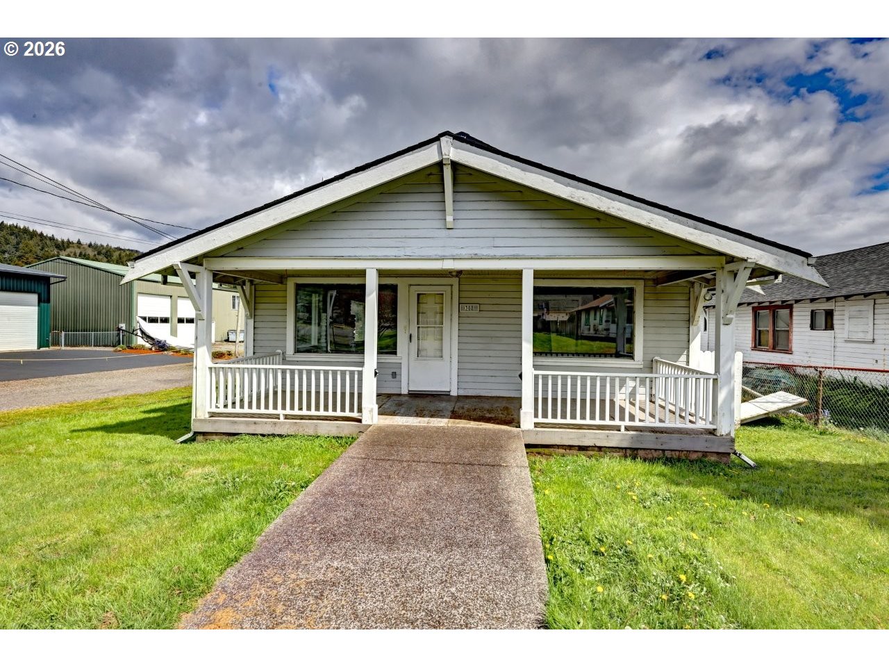 308 1st Street Garibaldi, OR 97118 - Photo 4 of 48 a front view of a house with a garden