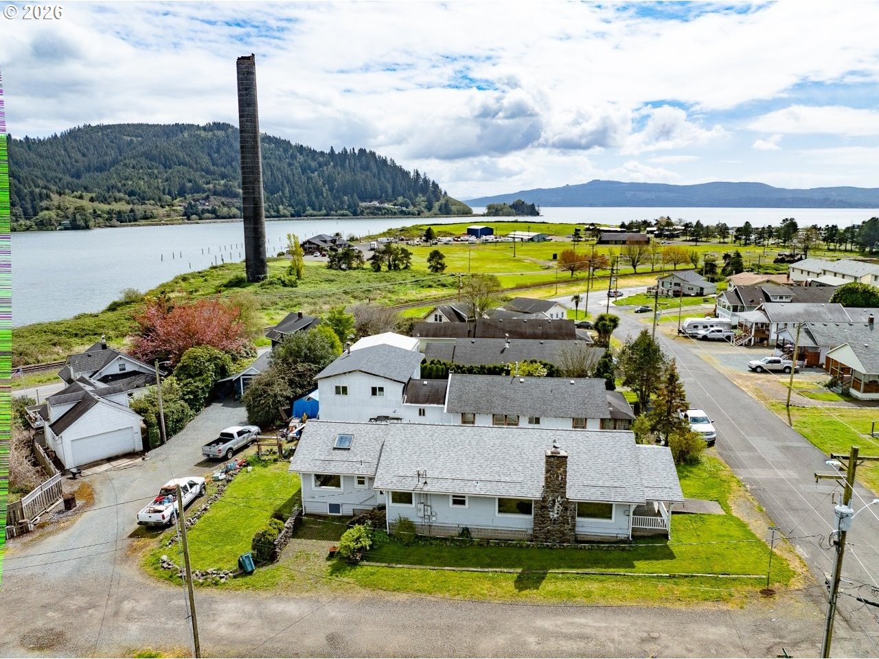 308 1st Street Garibaldi, OR 97118 - Photo 46 of 48 an aerial view of a house with a garden and lake view